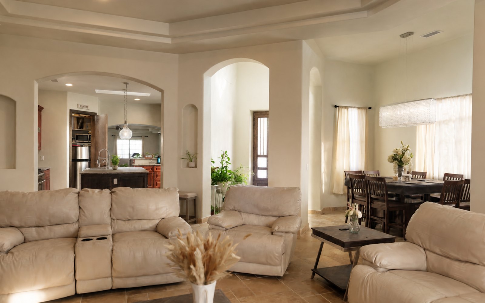 Open-plan living room of 2919 William Street in warm afternoon light, arches to the kitchen and dining room